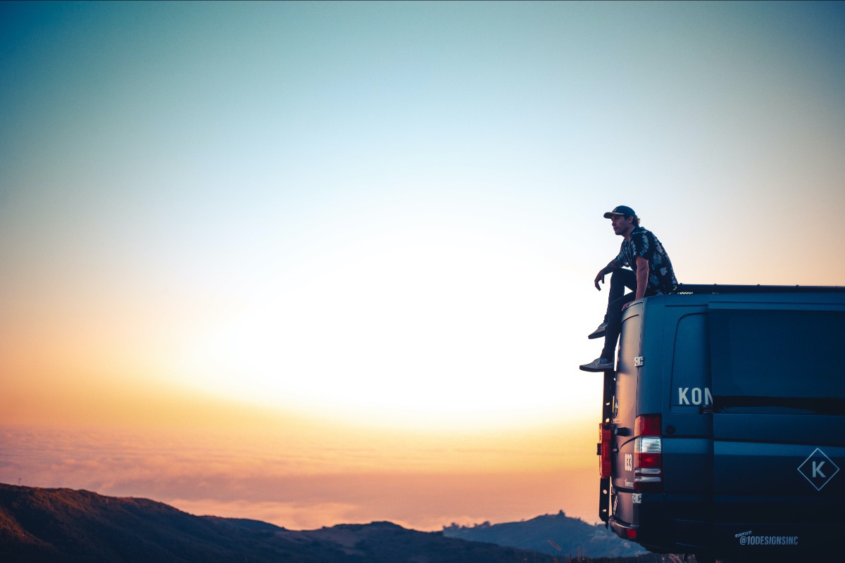 BMX X-Games athlete Coco Zurita sitting on top of sprinter van